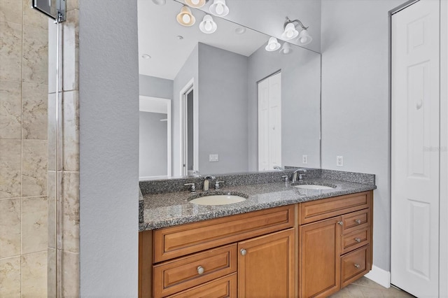 bathroom featuring vanity and tiled shower