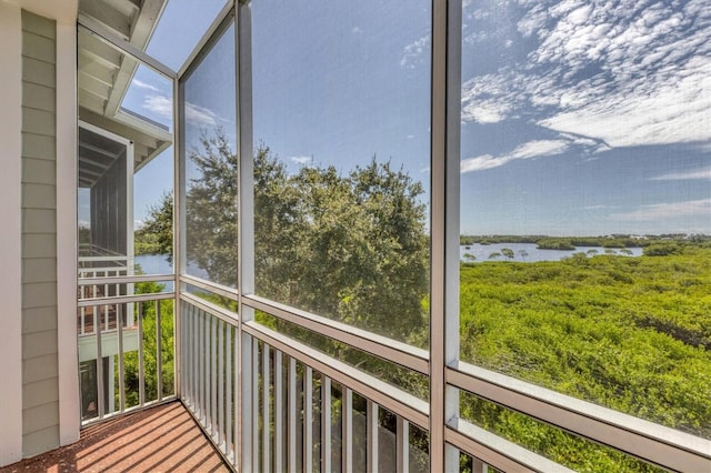 unfurnished sunroom with a water view