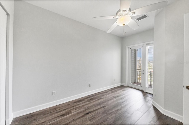 unfurnished room with dark hardwood / wood-style flooring and ceiling fan