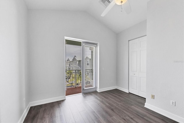 spare room featuring lofted ceiling, dark wood-type flooring, and ceiling fan