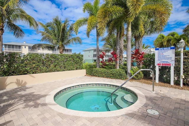 view of pool with a hot tub