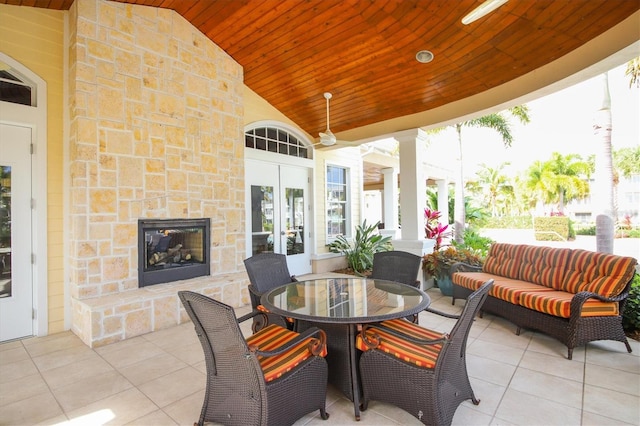 view of patio with an outdoor living space with a fireplace and french doors