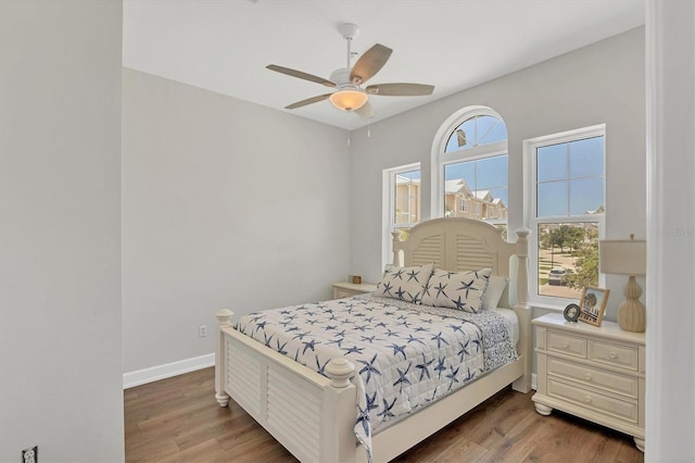 10360 Longshore Rd Unit 66, Placida, FL 33946 - bedroom featuring multiple windows, wood finished floors, and a ceiling fan