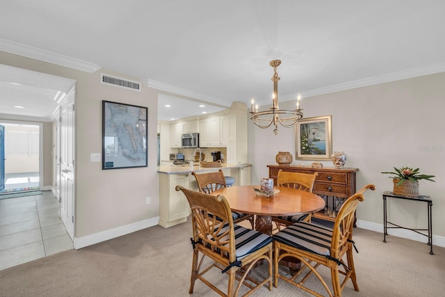 dining area with light carpet, an inviting chandelier, and crown molding