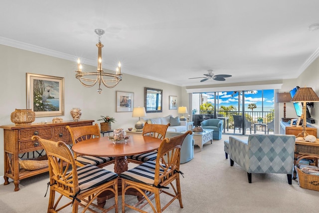 carpeted dining area featuring ornamental molding and ceiling fan with notable chandelier