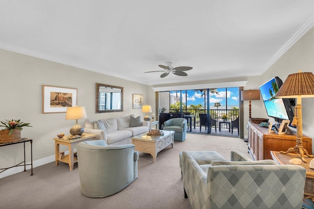 carpeted living room with ceiling fan and crown molding