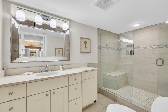 bathroom featuring an enclosed shower, vanity, tile patterned floors, and toilet