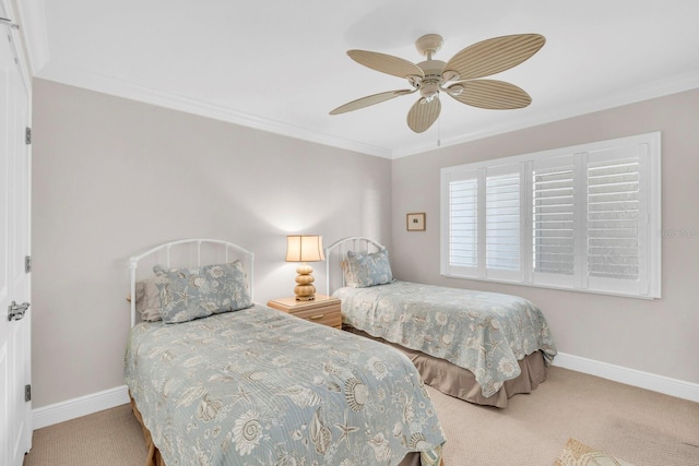 carpeted bedroom with ceiling fan and ornamental molding