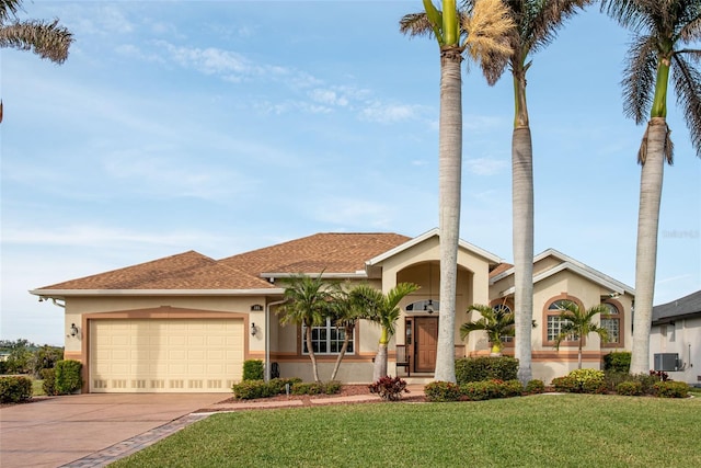 view of front of house with a garage and a front yard