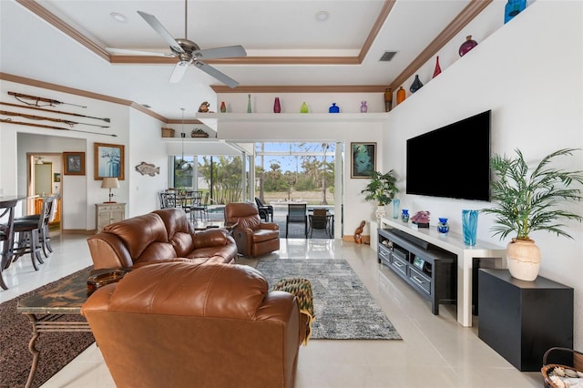 tiled living room featuring ceiling fan, crown molding, and a raised ceiling