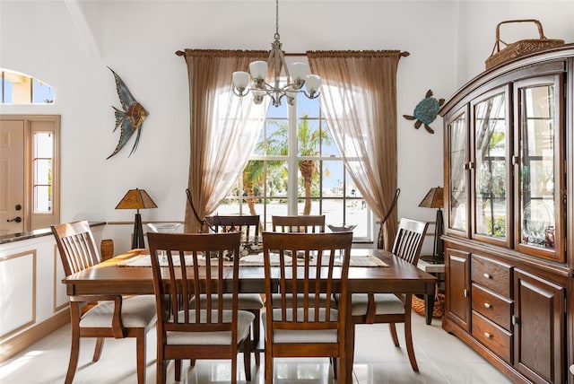 dining space with a notable chandelier and light tile patterned floors