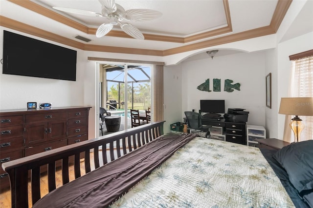 bedroom with ceiling fan, access to exterior, a tray ceiling, and crown molding