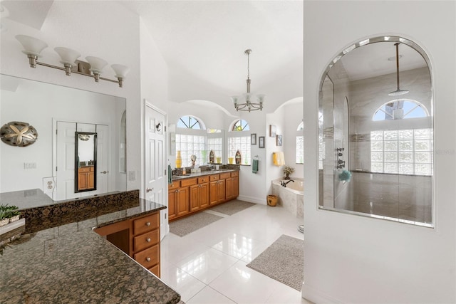 bathroom featuring vanity, a notable chandelier, tile patterned floors, and plenty of natural light