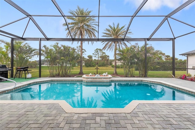 view of swimming pool with a patio, a lanai, and a yard