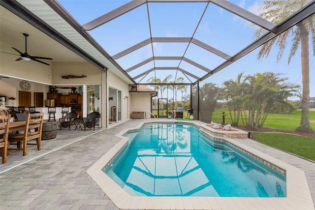 view of pool featuring ceiling fan, a lanai, and a patio