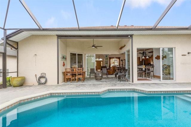 view of pool featuring a lanai, a patio, and ceiling fan