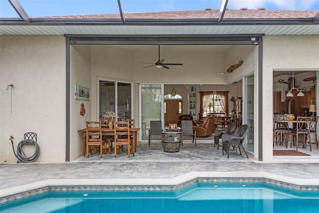 view of swimming pool with a lanai, a patio, and ceiling fan