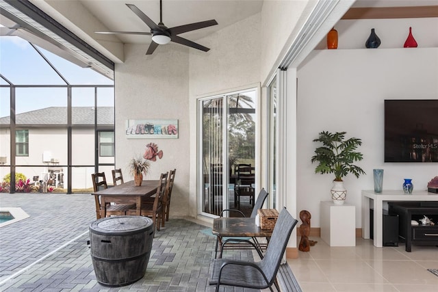 sunroom featuring ceiling fan and a wealth of natural light