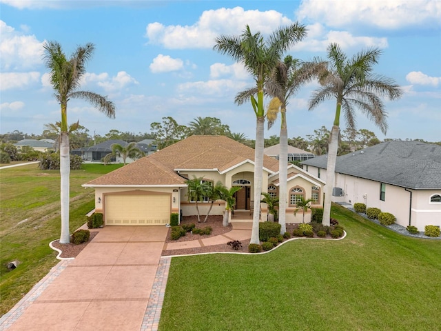 view of front of property with a garage and a front lawn