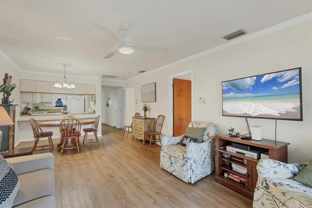 living room featuring ornamental molding, ceiling fan with notable chandelier, and light hardwood / wood-style floors