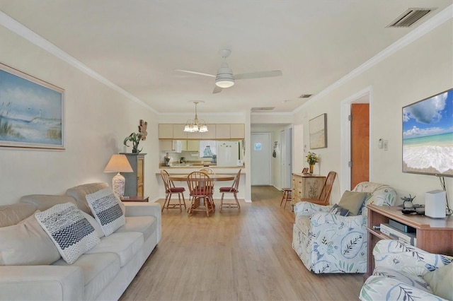 living room featuring ceiling fan with notable chandelier, ornamental molding, and light hardwood / wood-style floors