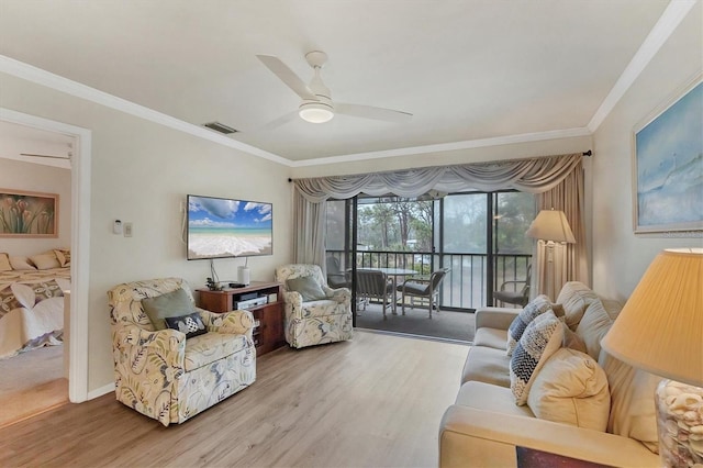 living room featuring hardwood / wood-style flooring, crown molding, and ceiling fan