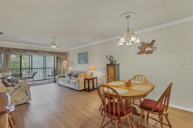 dining room with crown molding, ceiling fan with notable chandelier, and light hardwood / wood-style floors