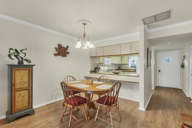 dining area with ornamental molding, a notable chandelier, and light hardwood / wood-style flooring