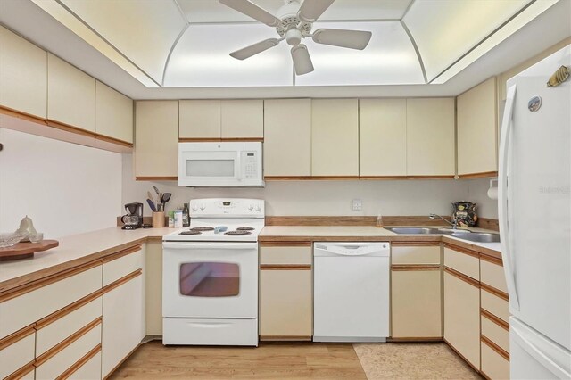 kitchen featuring sink, white appliances, cream cabinetry, and ceiling fan