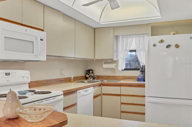 kitchen featuring ceiling fan, sink, white appliances, and cream cabinetry