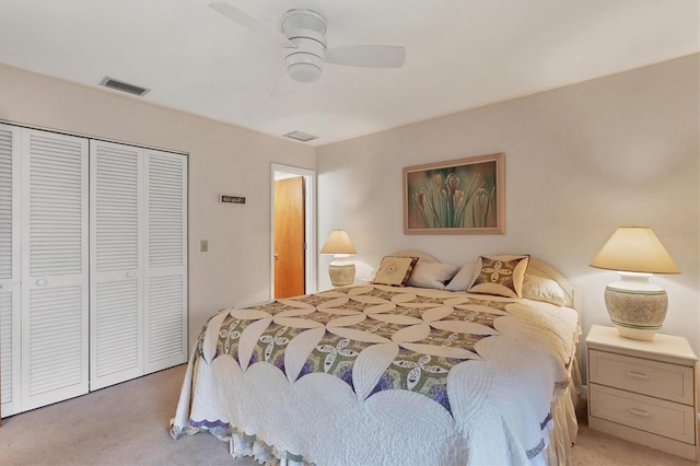 bedroom with ceiling fan, carpet, and a closet