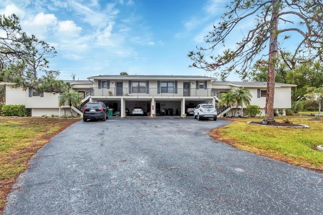 view of front of home with a front lawn and a carport