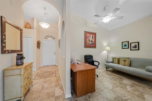 entryway with ceiling fan and high vaulted ceiling