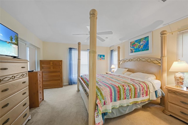 bedroom with ceiling fan and light colored carpet