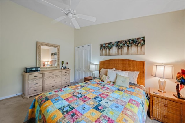 carpeted bedroom with vaulted ceiling, ceiling fan, and a closet