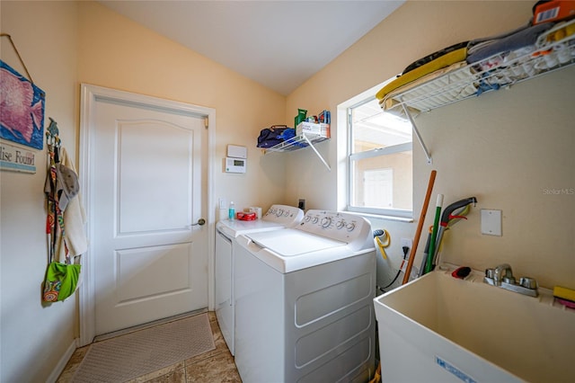 clothes washing area with independent washer and dryer and sink