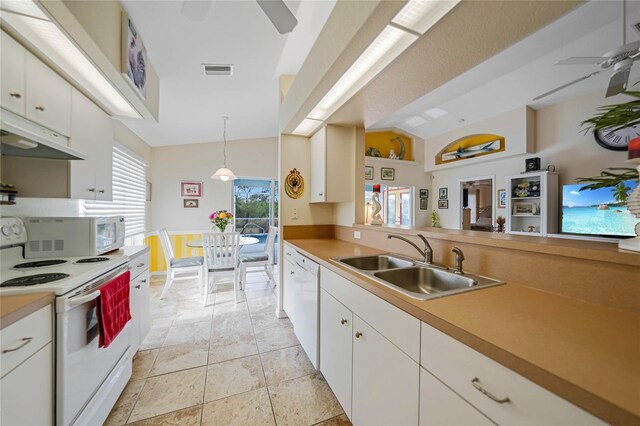 kitchen with white appliances, sink, white cabinetry, ceiling fan, and hanging light fixtures