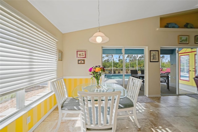 dining area featuring french doors and vaulted ceiling