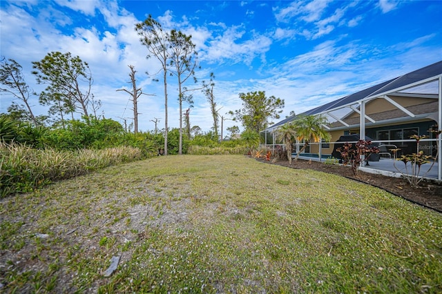 view of yard with a lanai