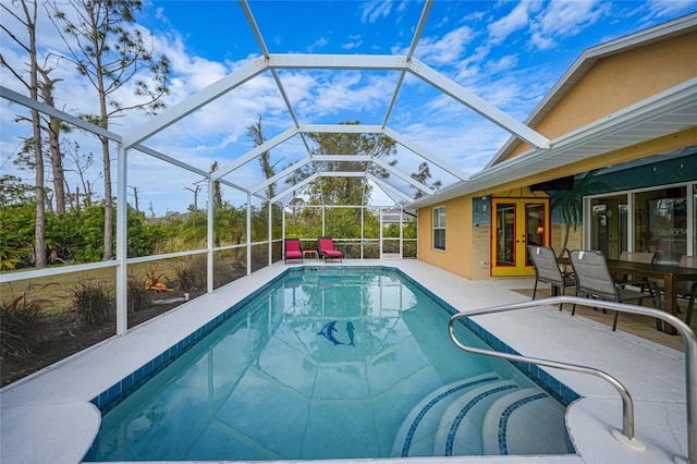 view of swimming pool featuring a patio area and a lanai