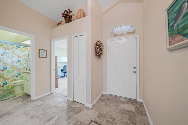 215 Australian Dr, Rotonda West, FL 33947 - entrance foyer with baseboards and light stone finish flooring