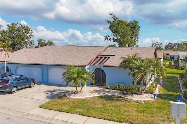 view of front of home featuring a garage and a front yard