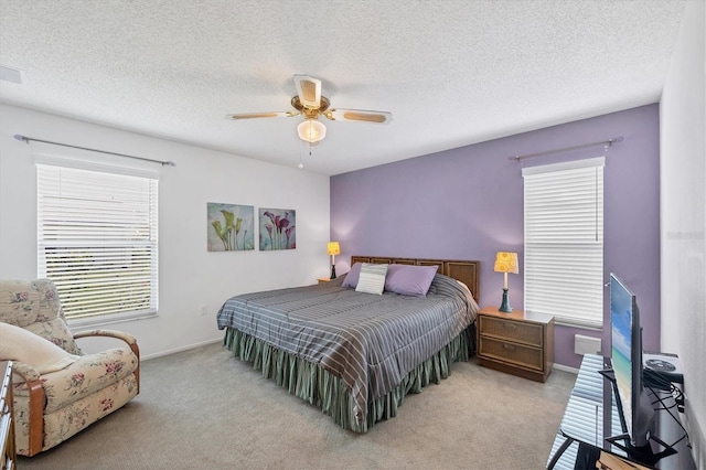 carpeted bedroom with a textured ceiling and ceiling fan