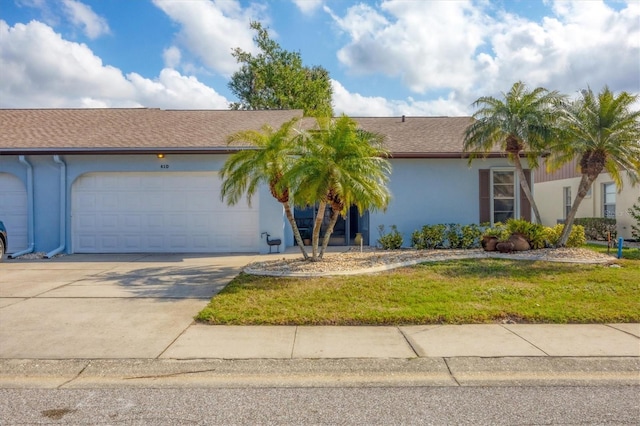 view of front of house with a garage and a front yard