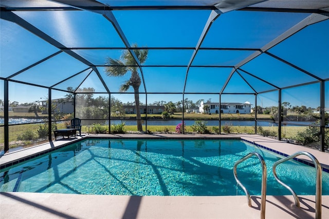 view of pool featuring a water view, glass enclosure, and a patio area