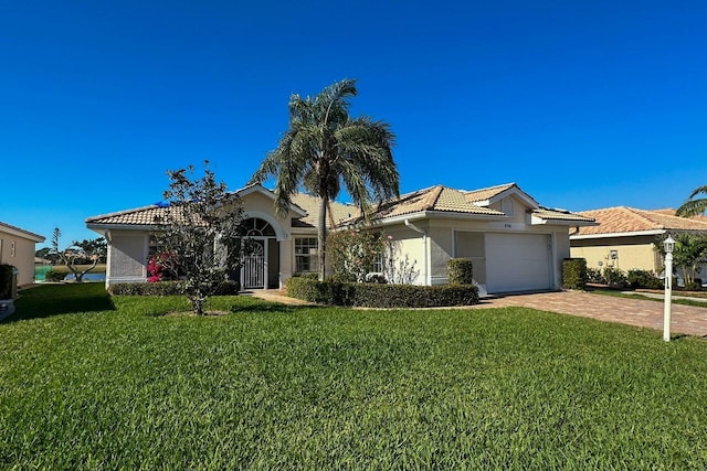 view of front of house with a garage and a front lawn