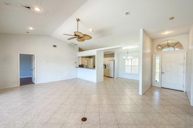 foyer entrance with light tile patterned flooring, lofted ceiling, and ceiling fan with notable chandelier