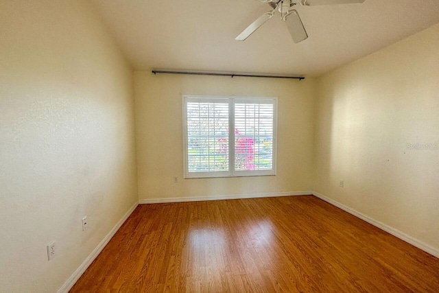 unfurnished room with hardwood / wood-style floors and ceiling fan