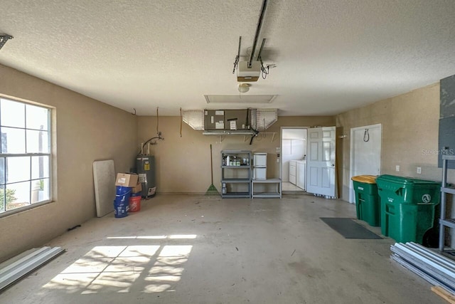 garage with washer and clothes dryer and water heater