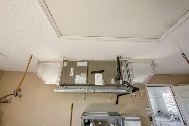 interior details featuring washer and dryer and a textured ceiling